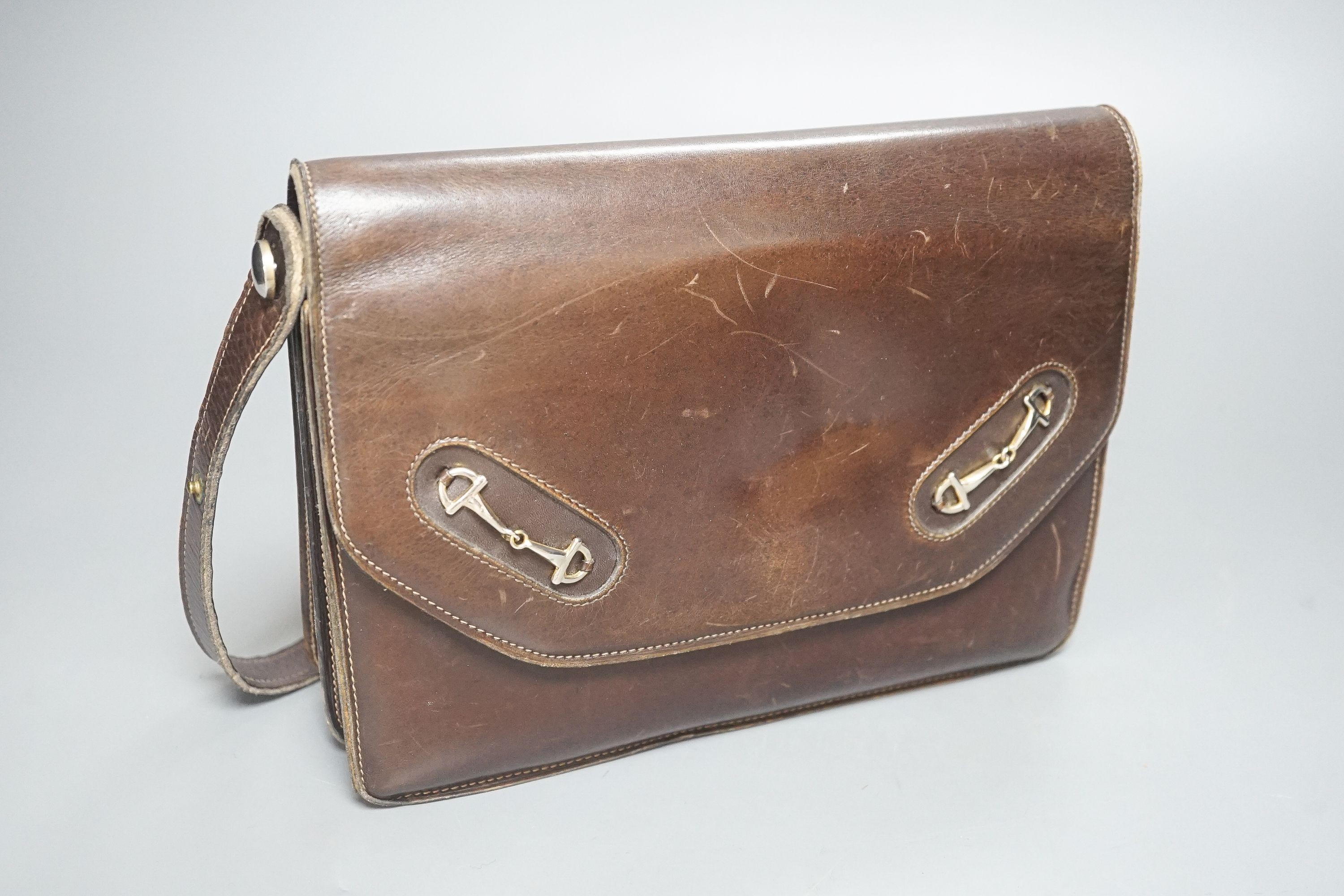 A vintage brown leather handbag stamped 